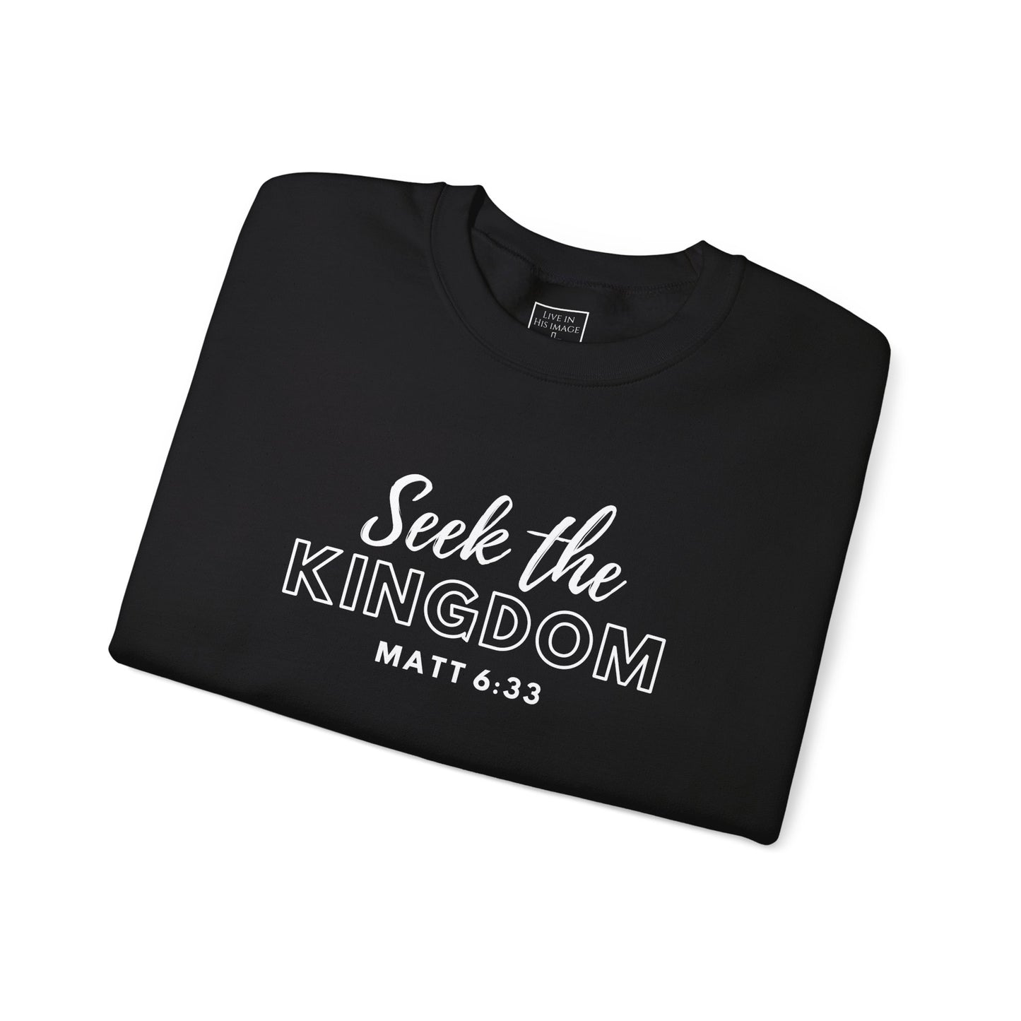 Folded black crewneck sweatshirt with "Seek the Kingdom" and scripture "Matt 6:33" written in white